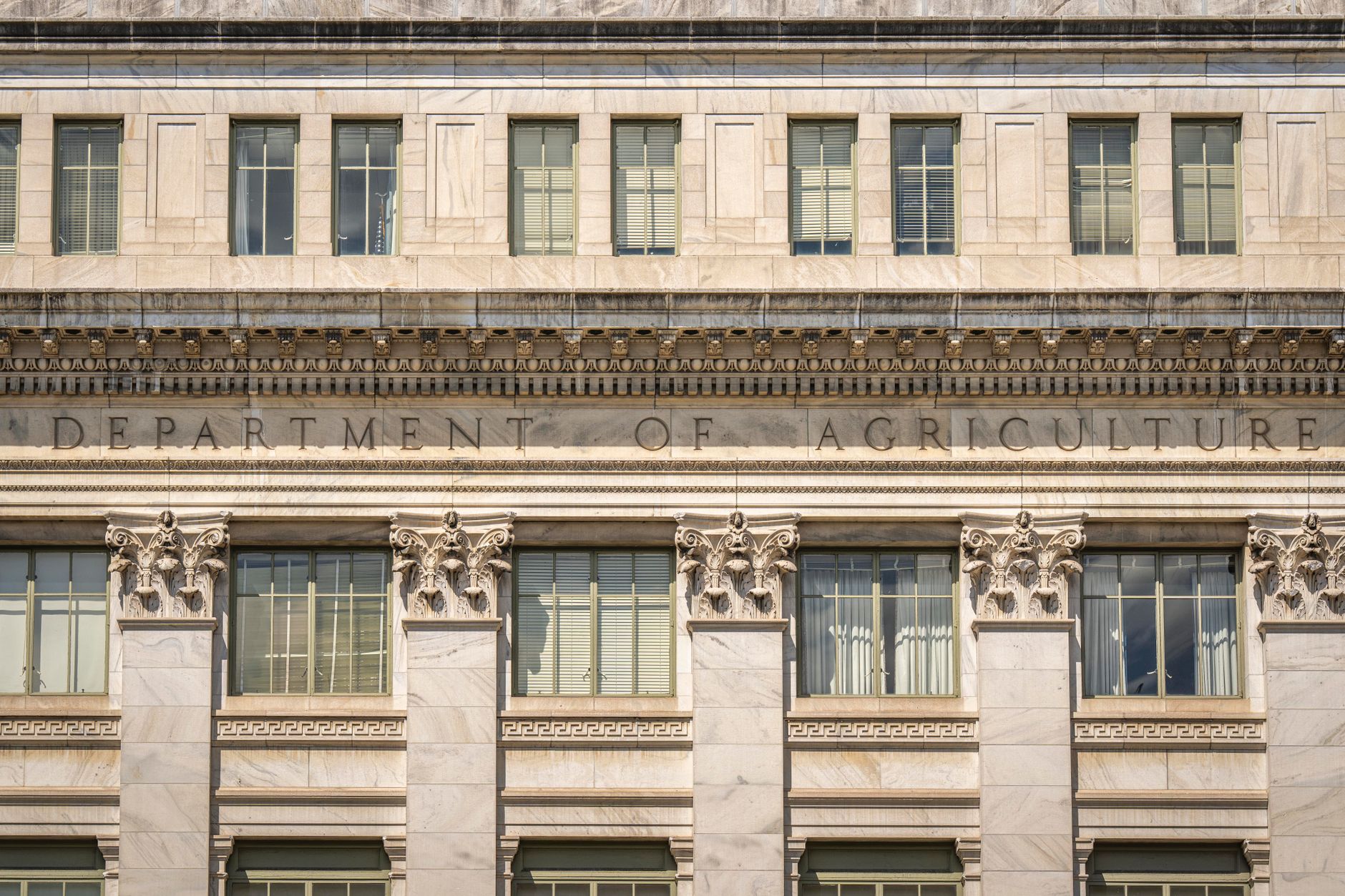 Close up of the Department of Agriculture building's architectural facade, showcasing intricate columns and windows.