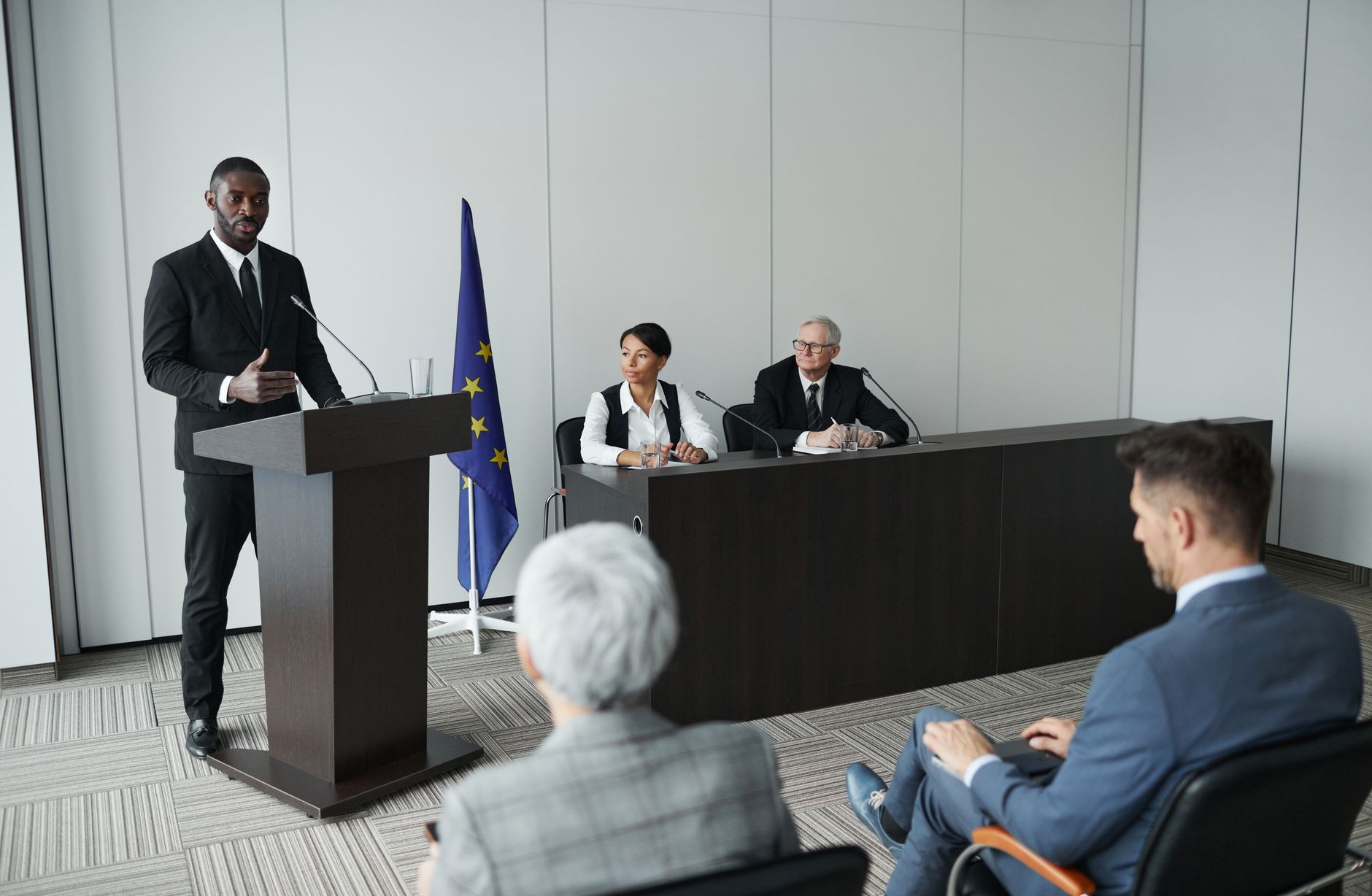 Business presentation featuring a diverse group of professionals discussing at a conference.