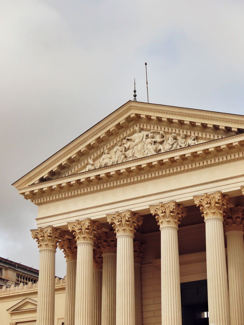 Neoclassical facade of a historic court building with ornate columns and reliefs, located in Montpellier, France.