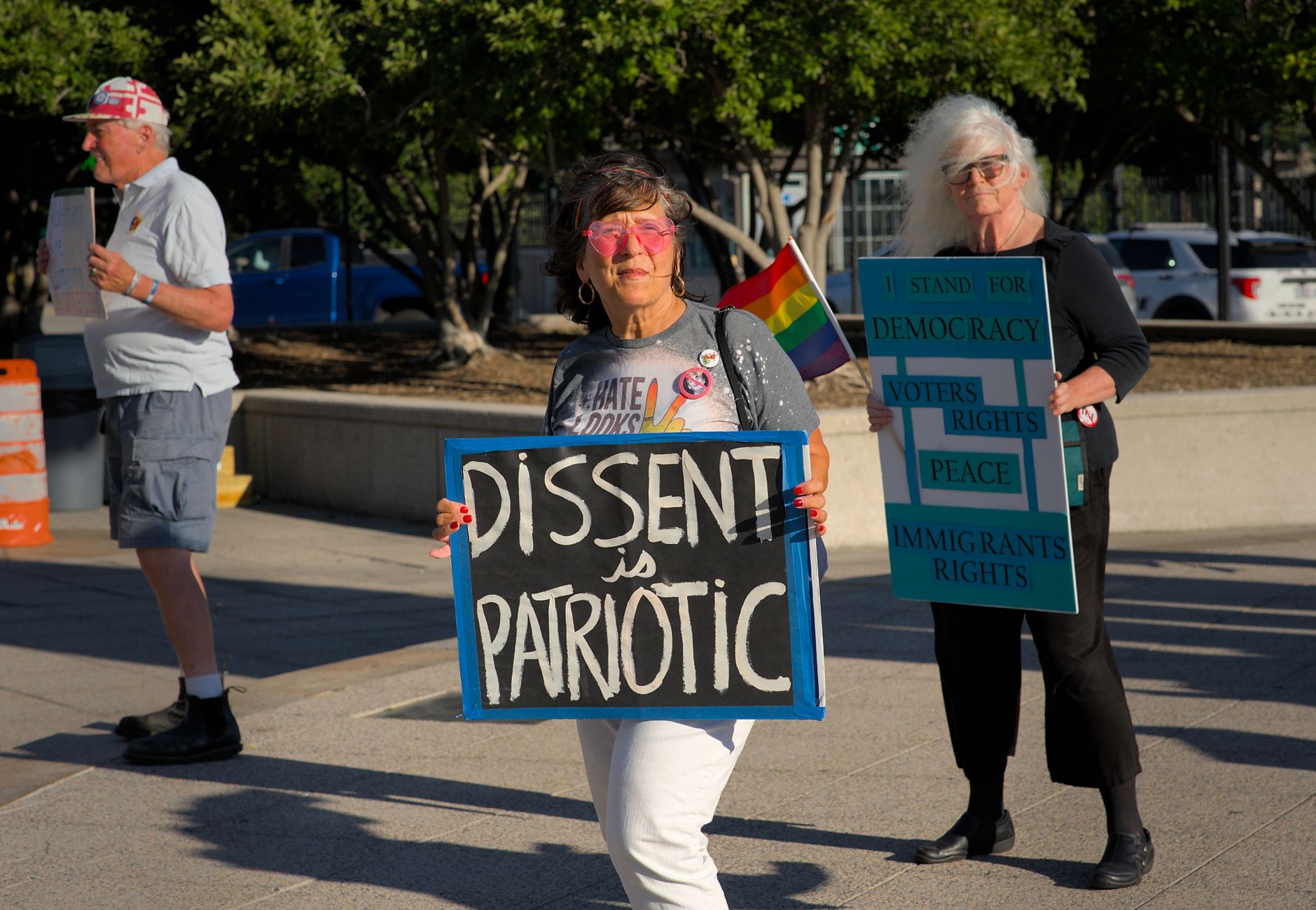 A peaceful protest in Baltimore with signs supporting democracy and immigrant rights.