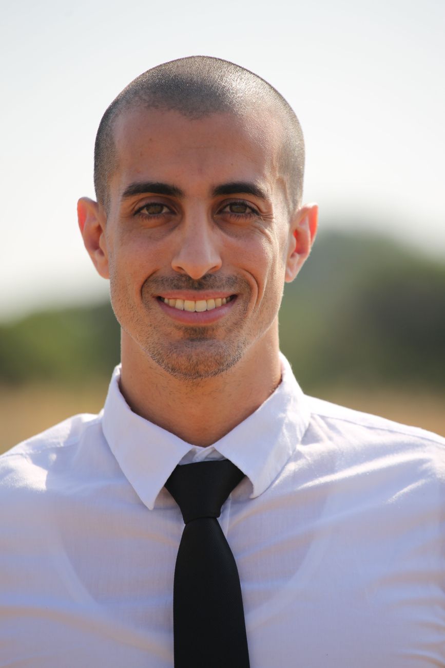 Portrait of a smiling businessman in a tie enjoying the outdoors, showcasing confidence and professionalism.