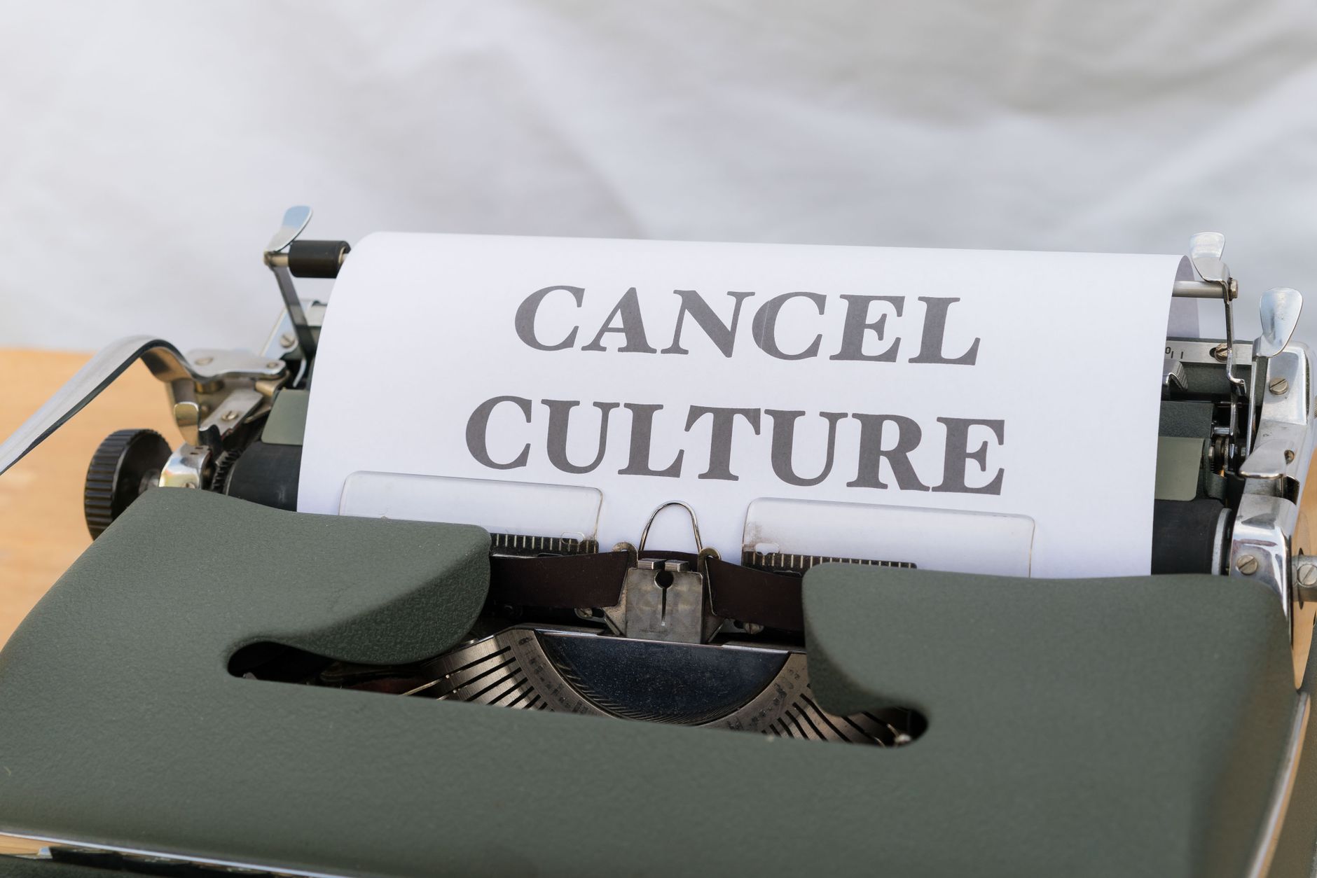 Close up of a vintage typewriter with paper reading 'Cancel Culture', signifying social media trends.