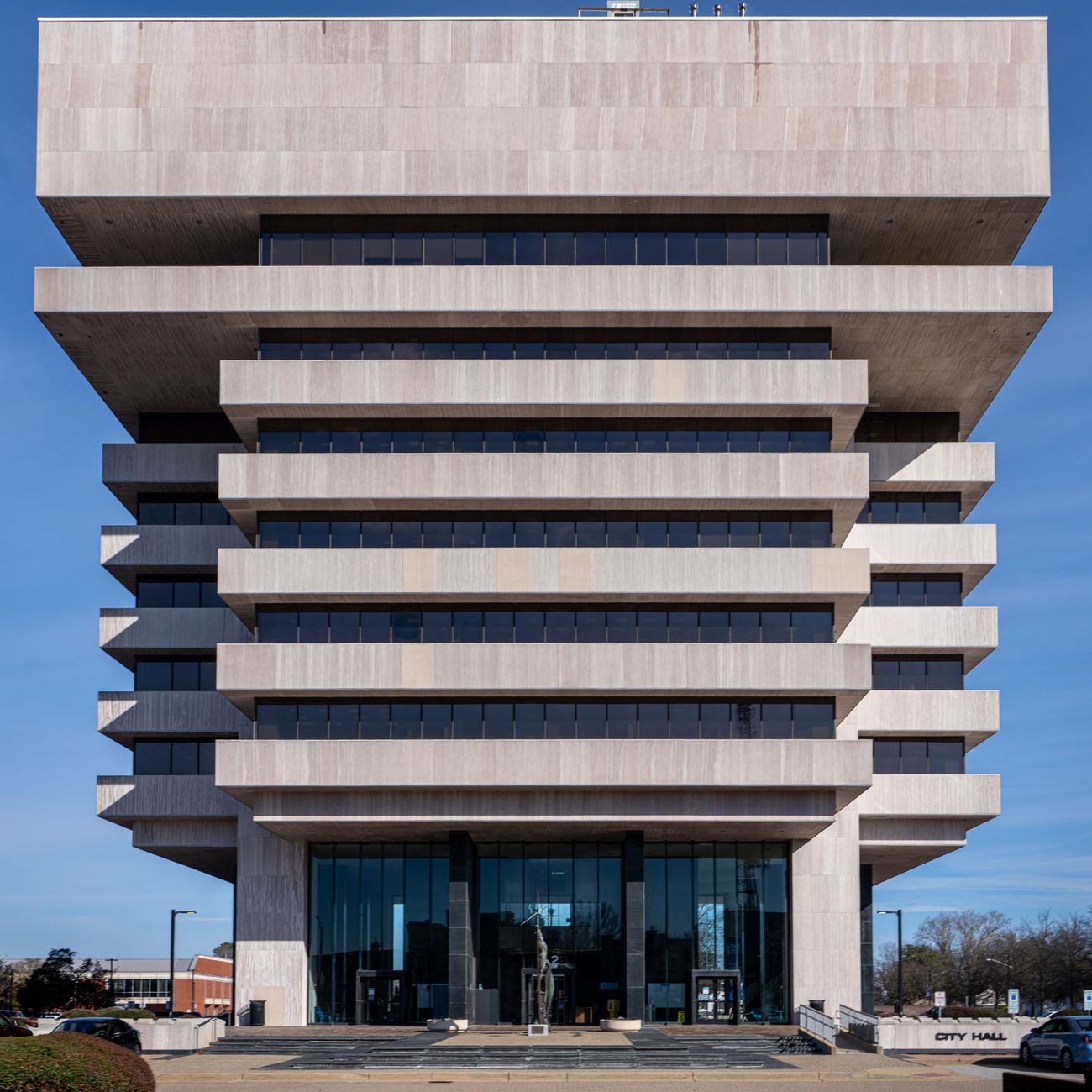 Front view of Hampton City Hall showcasing its striking Brutalist design on a sunny day.