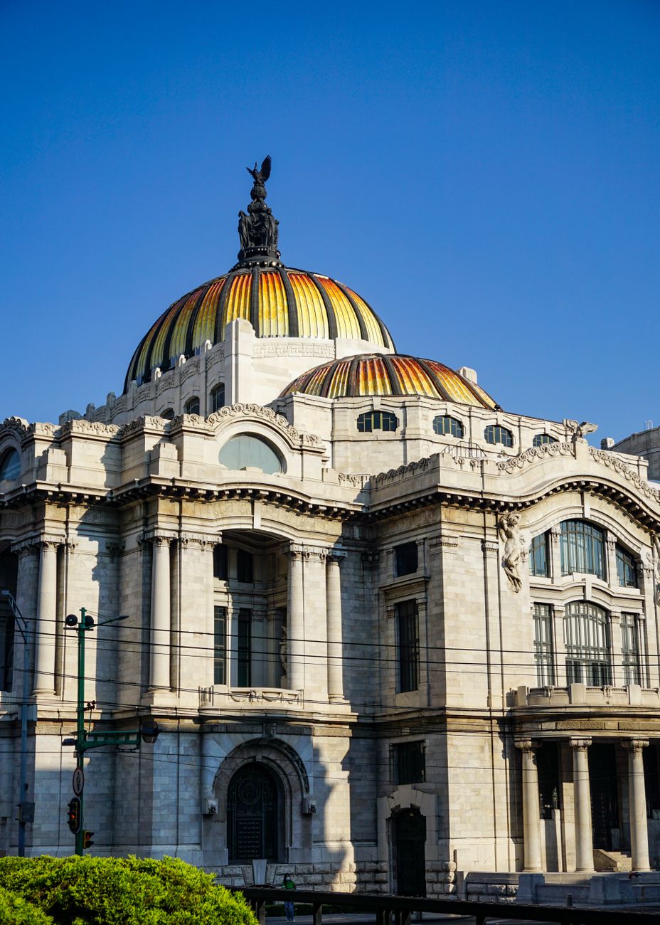 Explore the majestic architecture of Palacio de Bellas Artes in Mexico City with its iconic dome.