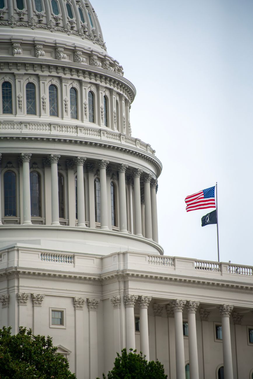 Close up view of U.S. Capitol dome and American flag in Washington, D.C.