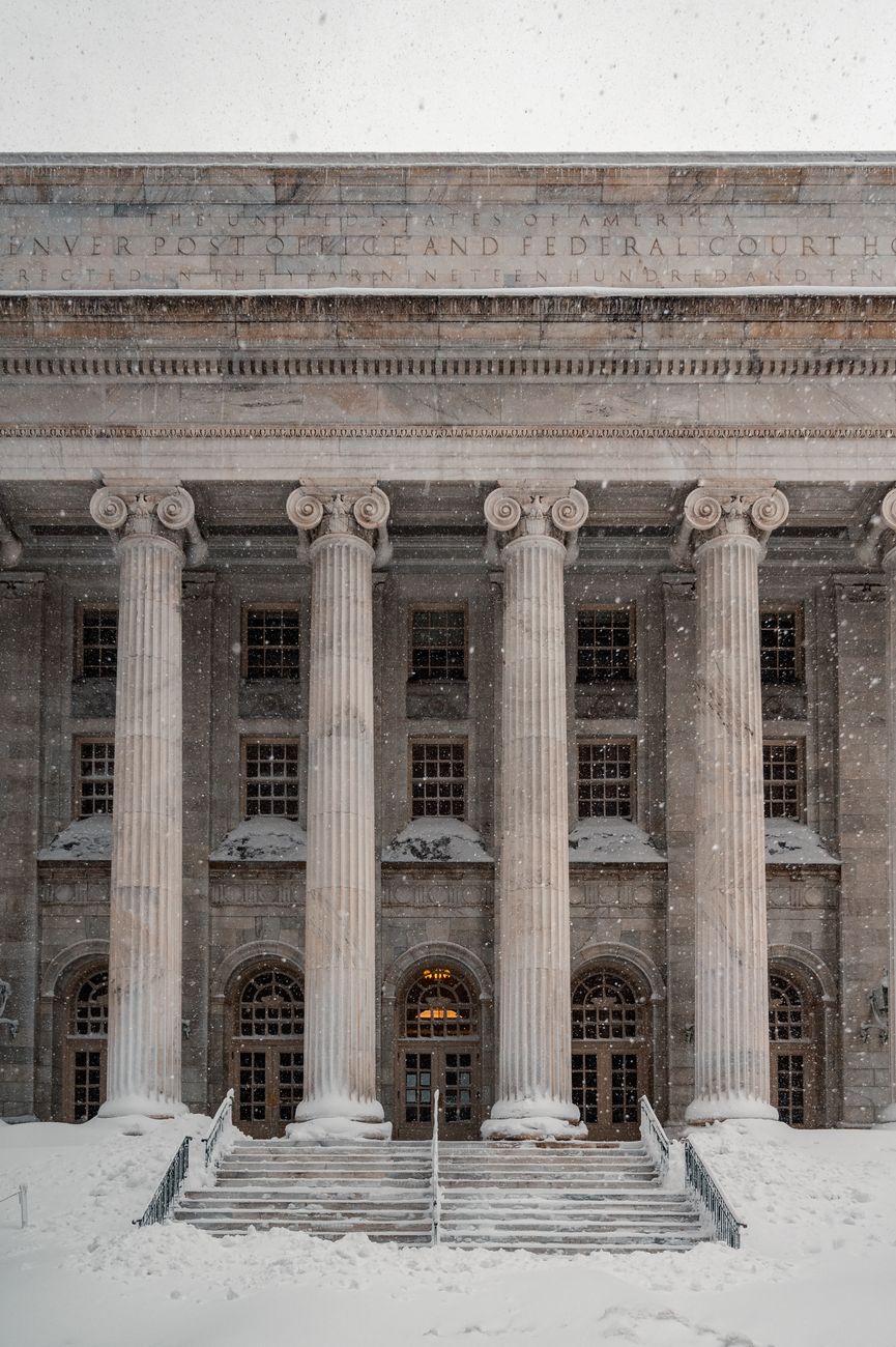 Denver courthouse during a winter snowstorm highlighting its neoclassical architecture.