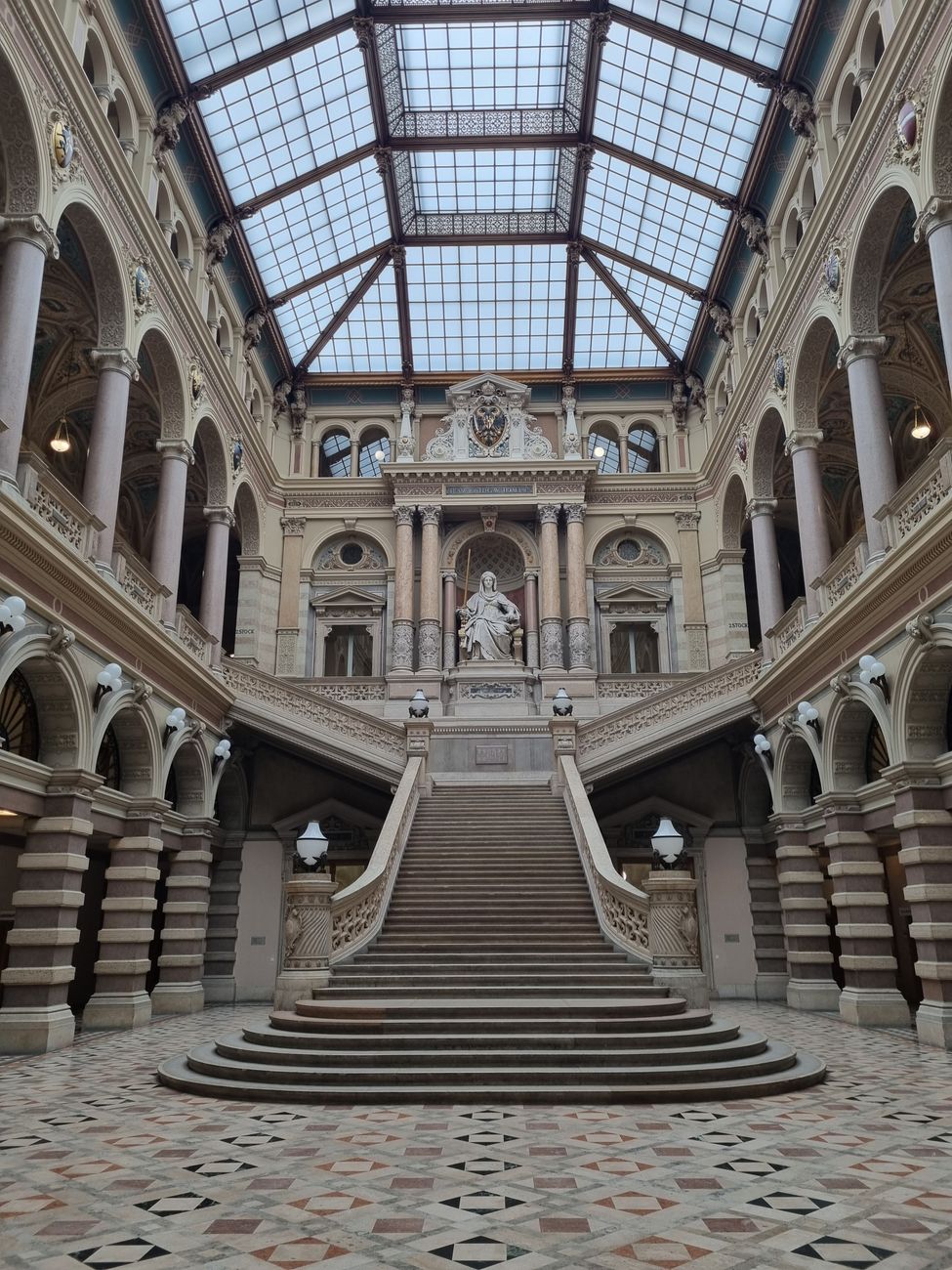 Elegant staircase inside the Justizpalast in Vienna, Austria, showcasing classic architectural beauty.